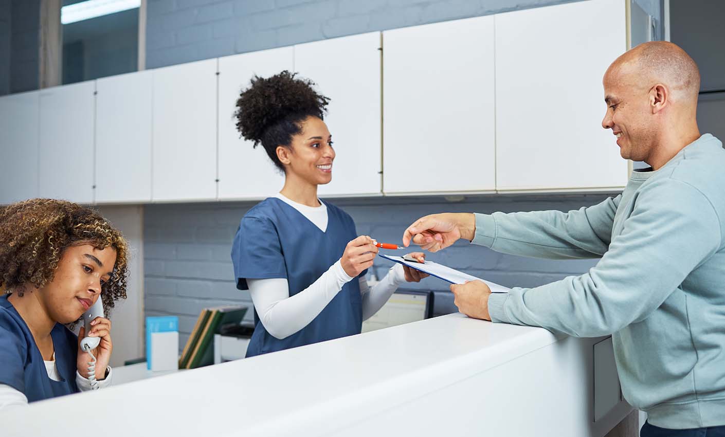 Patient signing form at reception