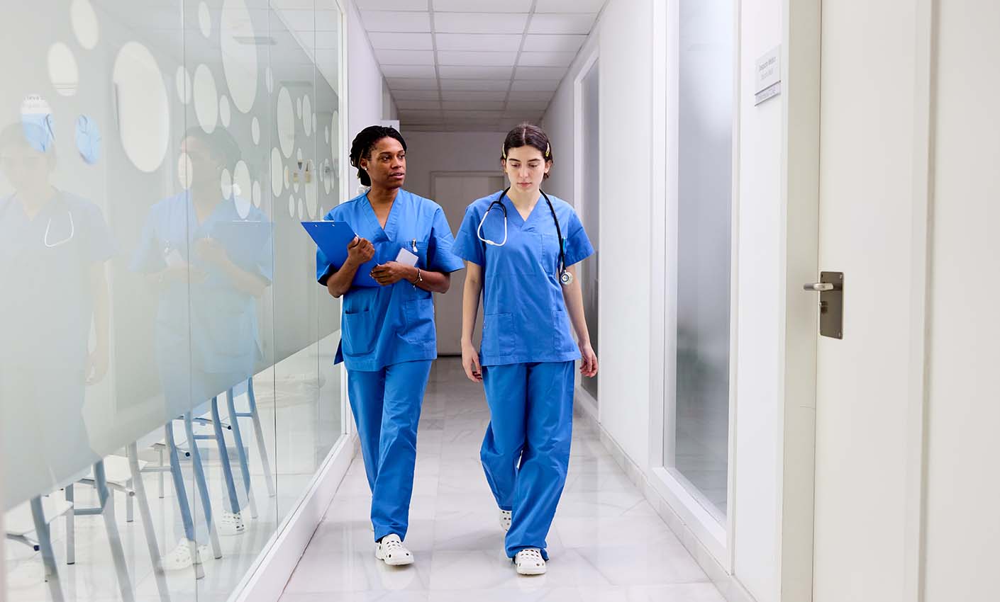 Clinical professionals walk together in corridor