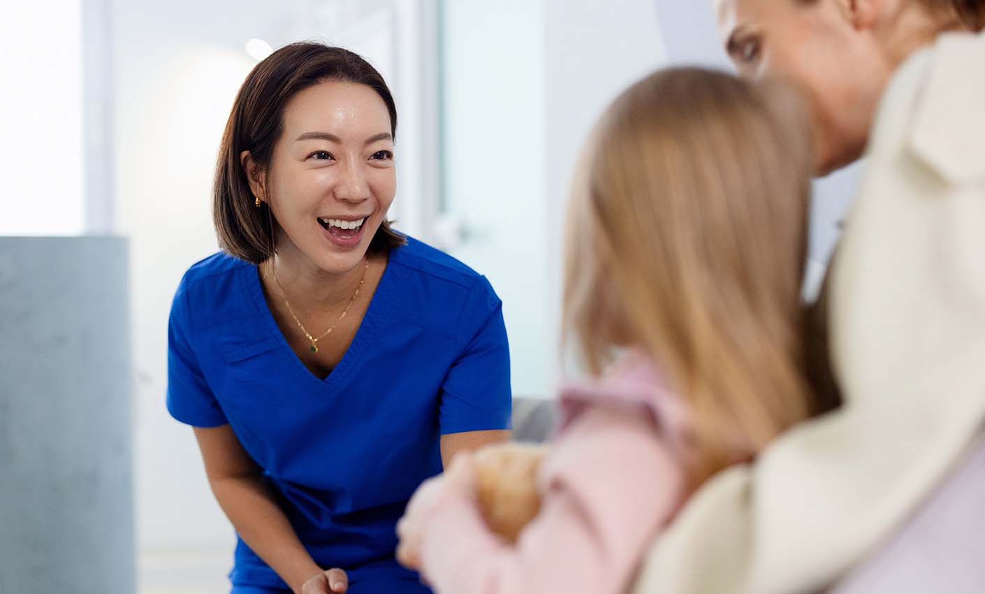 Doctor smiling at young patient